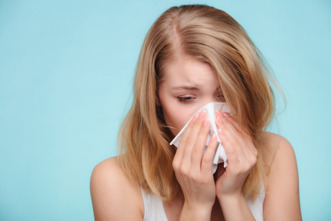 woman sneezing with hayfever
